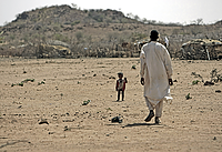 Sudan: Nomad and his son: A nomad and his son in Darfur, Sudan, live in what is already a marginal climate. Even small shifts in rainfall and temperature can make this land unihabitable.   UN Photo/Stuart Price