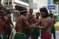 Hiparidi Top’tiro shakes hands with Krahó men who won a log race that was part of a meeting of Indigenous leaders in São Paulo in 2004. Their meeting helped to lay the ground work for the founding of MOPIC in 2007. Photo courtesy of Sylvia Caiuby Novaes.