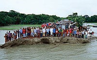 Bhola Island in Bangladesh is rapidly shrinking as the water rises around it. Photo by Gary Braasch