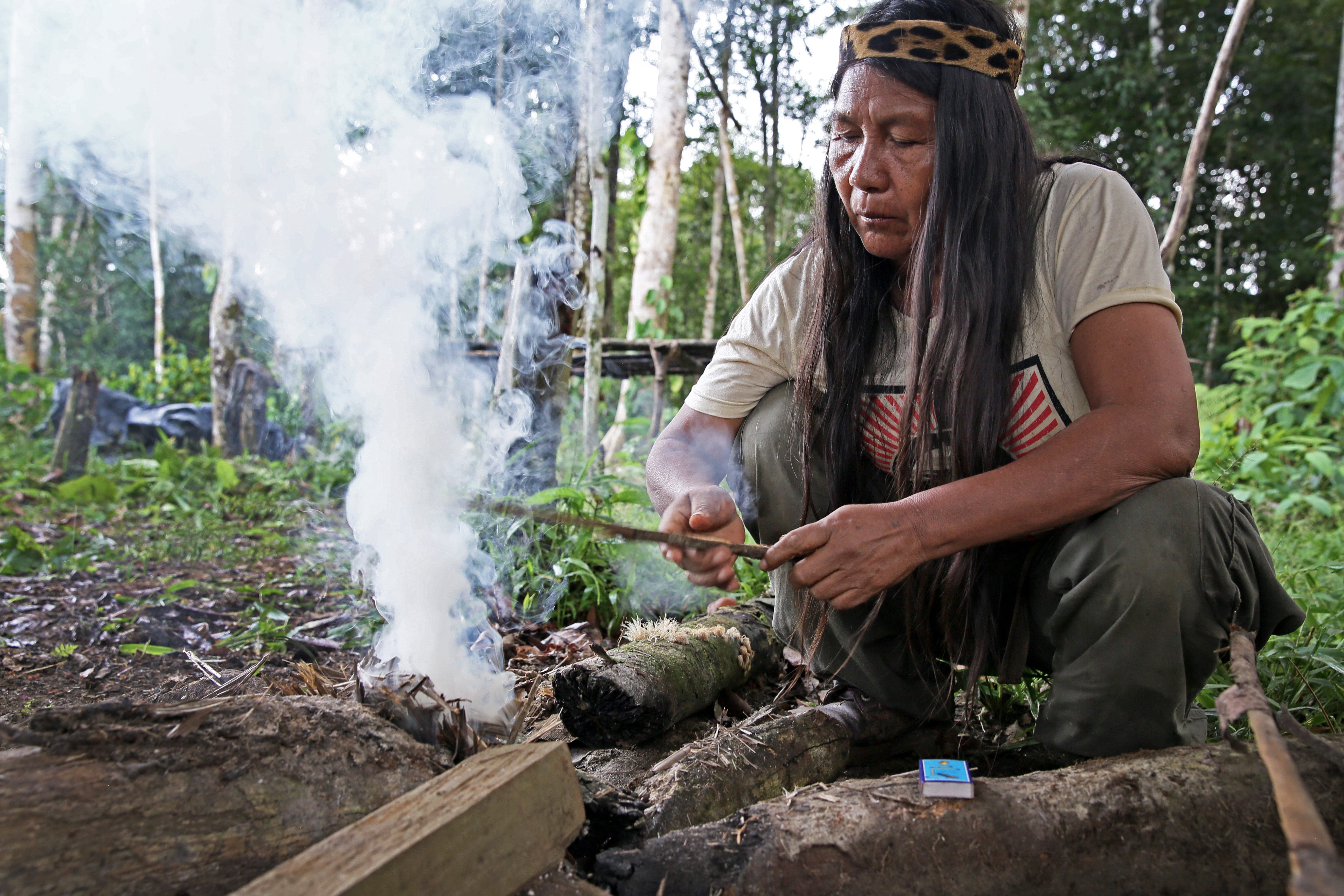 Amazon rainforest reflected in rainwater filling a Sápara dugout canoe, Ecuador.  Photo © Gleb Raygorodetsky