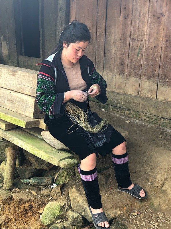Lan, Hmong artisan partner, splicing hemp fibers
