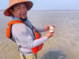 Hickory Edwards finding fresh clams in the Shinnecock Bay. Photo taken by Ryan Ranco Kelly_