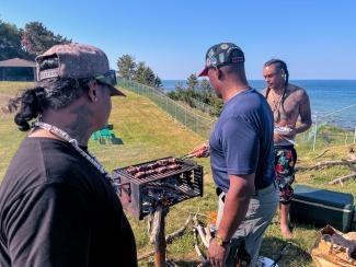 Larry Fisher, Reginald L. Bullock, and Andre Strongheart Bear Gaines grilling moose meat at camp. Photo by Chenae Bullock